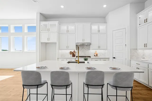 a kitchen with counter top space cabinets and appliances