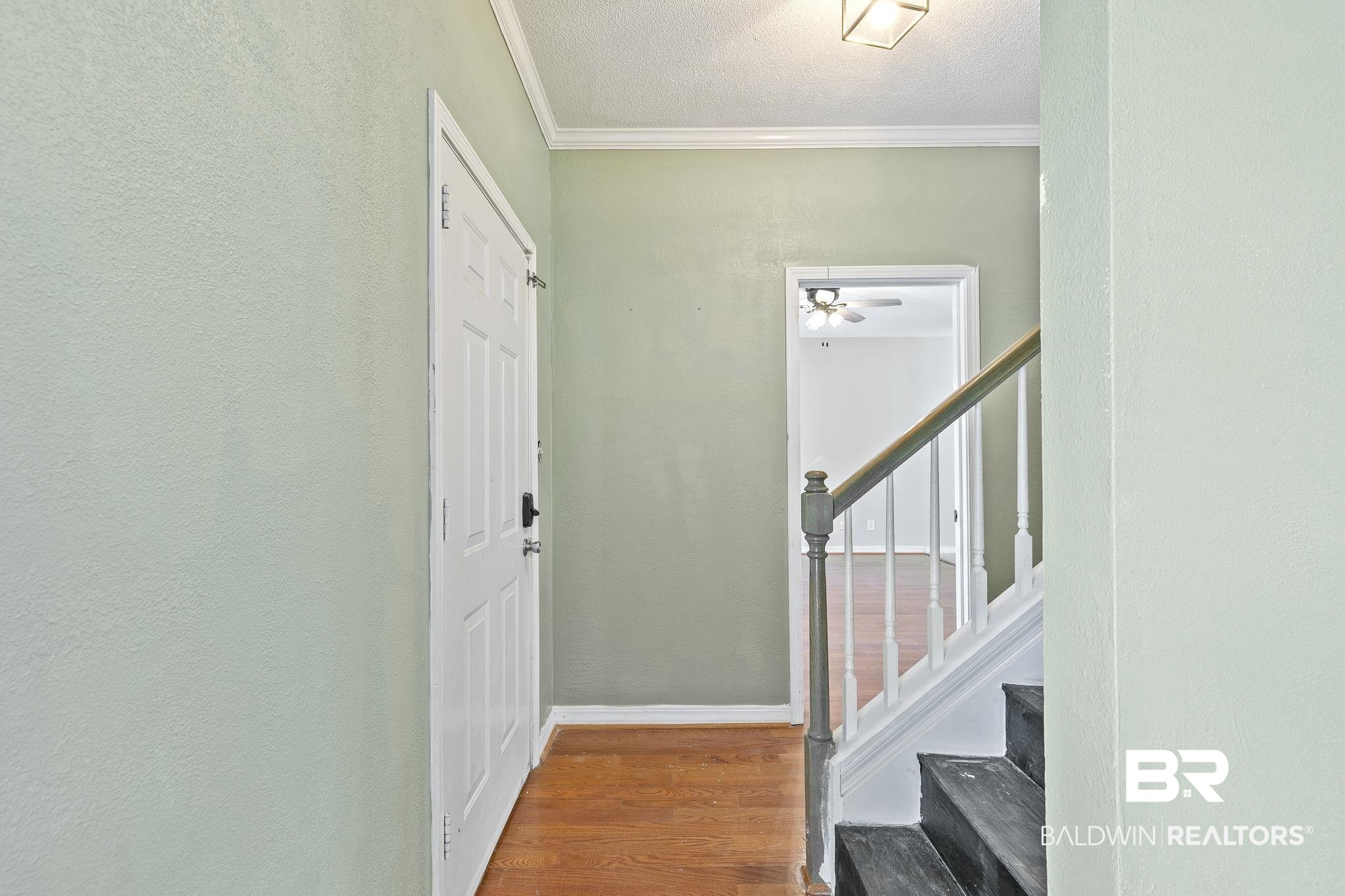 474 Ridgewood Drive Daphne, AL 36526 - Photo 11 of 57 Entryway with ornamental molding, a textured ceiling, wood-type flooring, and ceiling fan