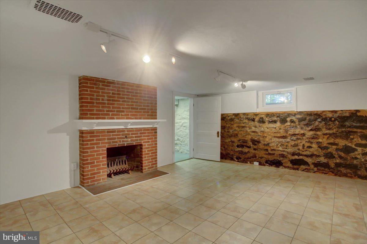 18902 Preston Road Hagerstown, MD 21742 - Photo 46 of 54 a view of an empty room with wooden floor and a fireplace