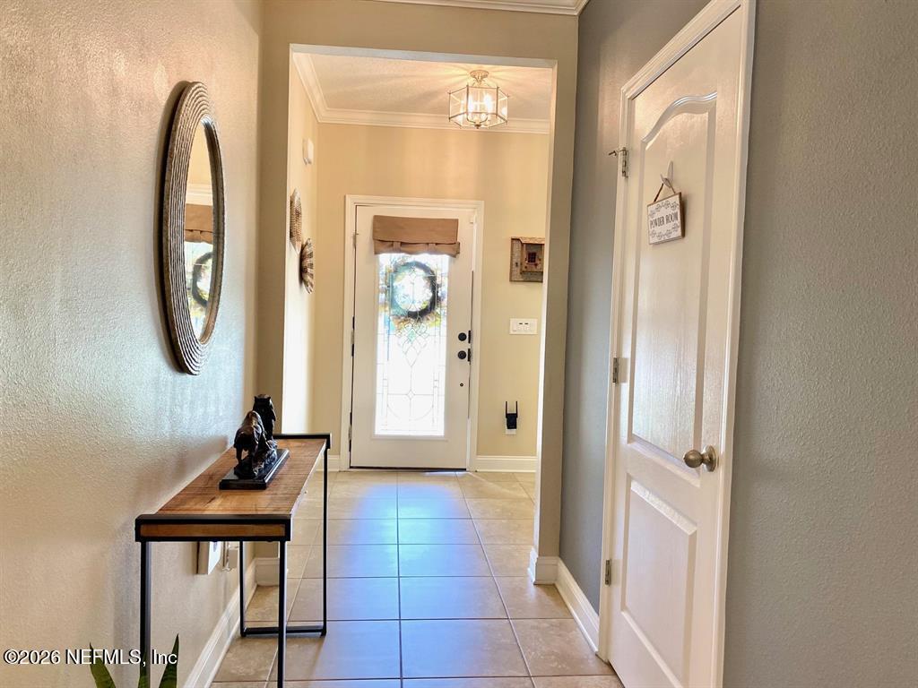 115 Sierras Loop St. Augustine, FL 32086 - Photo 11 of 65 a view of a hallway with entryway wooden floor and front door