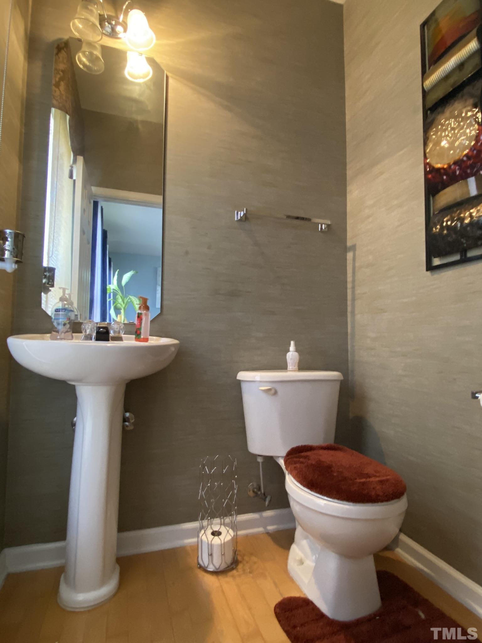 7251 Galon Glen Road Raleigh, NC 27613 - Photo 13 of 26 a bathroom with a sink and a toilet