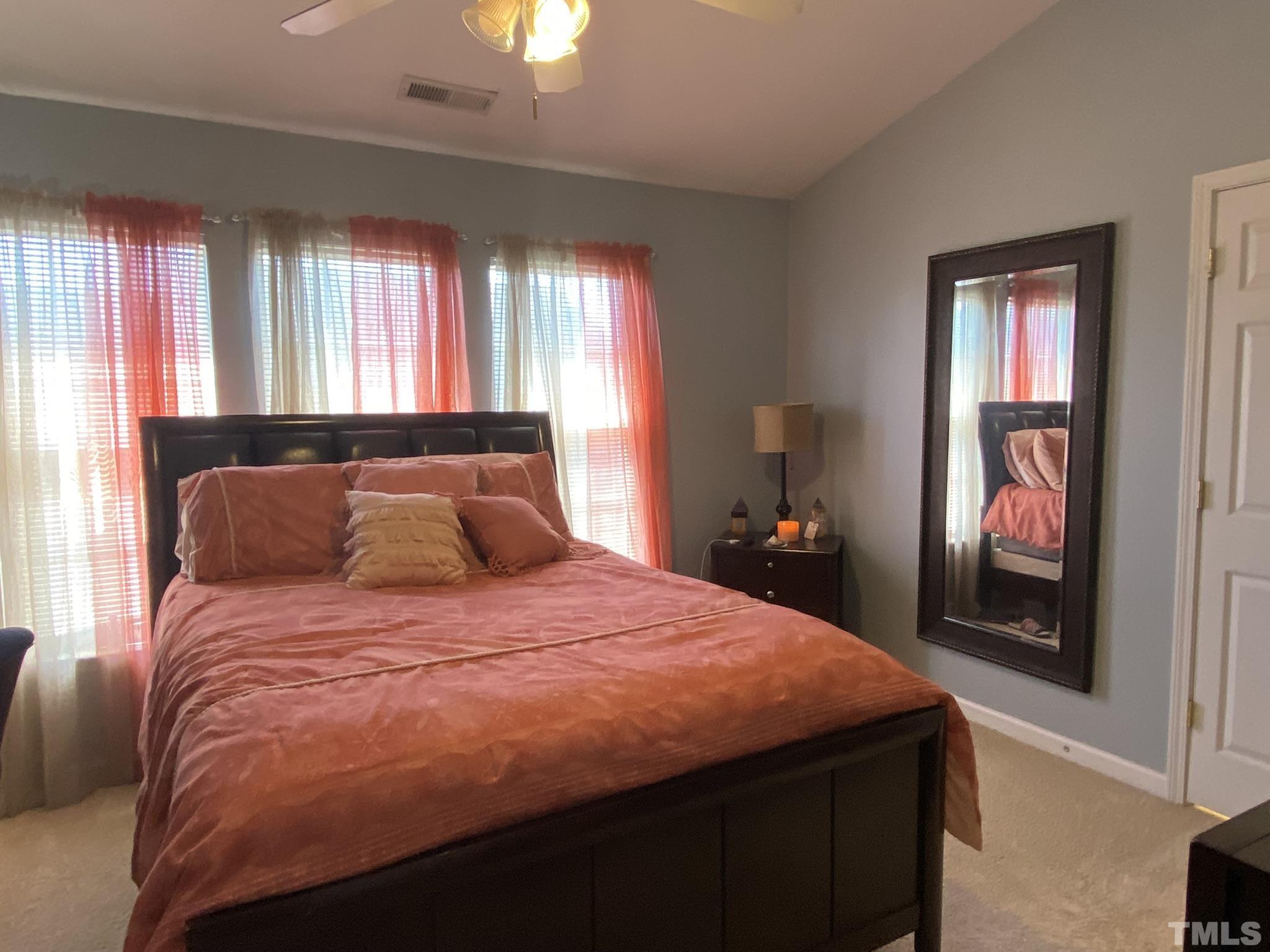 7251 Galon Glen Road Raleigh, NC 27613 - Photo 15 of 26 a large bed sitting in a bedroom next to a window