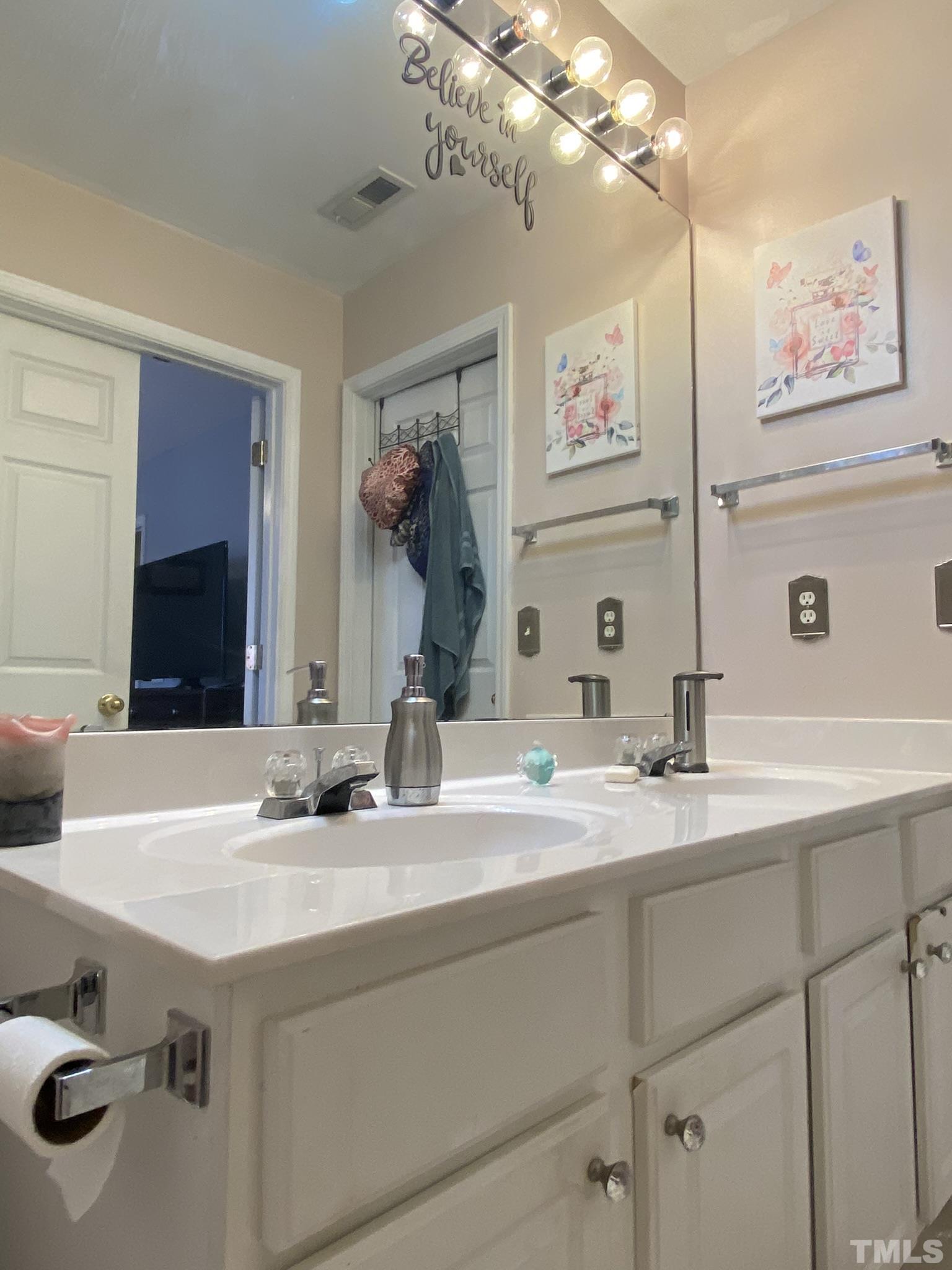 7251 Galon Glen Road Raleigh, NC 27613 - Photo 16 of 26 a bathroom with a sink and a mirror