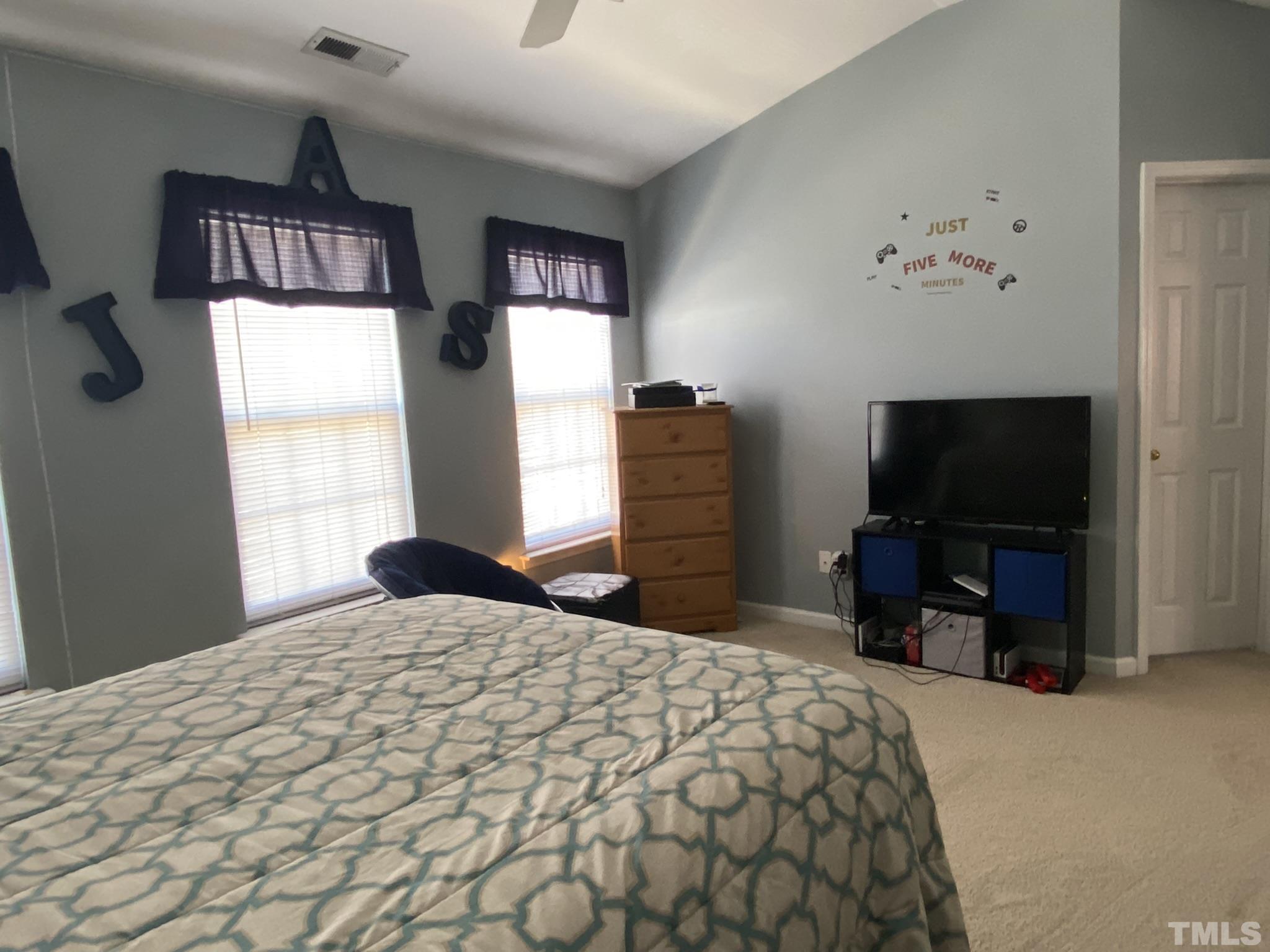 7251 Galon Glen Road Raleigh, NC 27613 - Photo 19 of 26 a bedroom with a bed and a flat screen tv