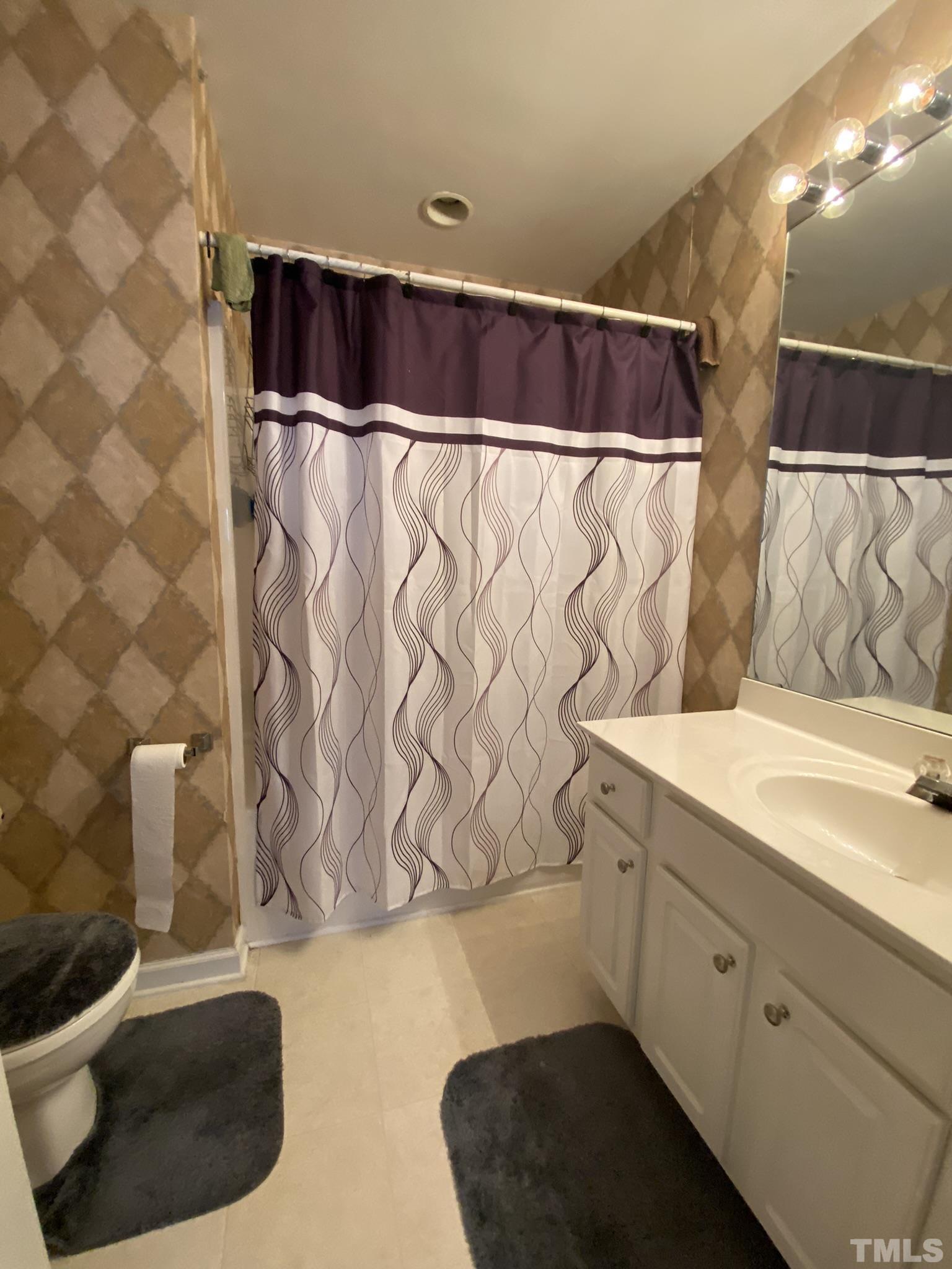 7251 Galon Glen Road Raleigh, NC 27613 - Photo 20 of 26 a bathroom with a bathtub and shower