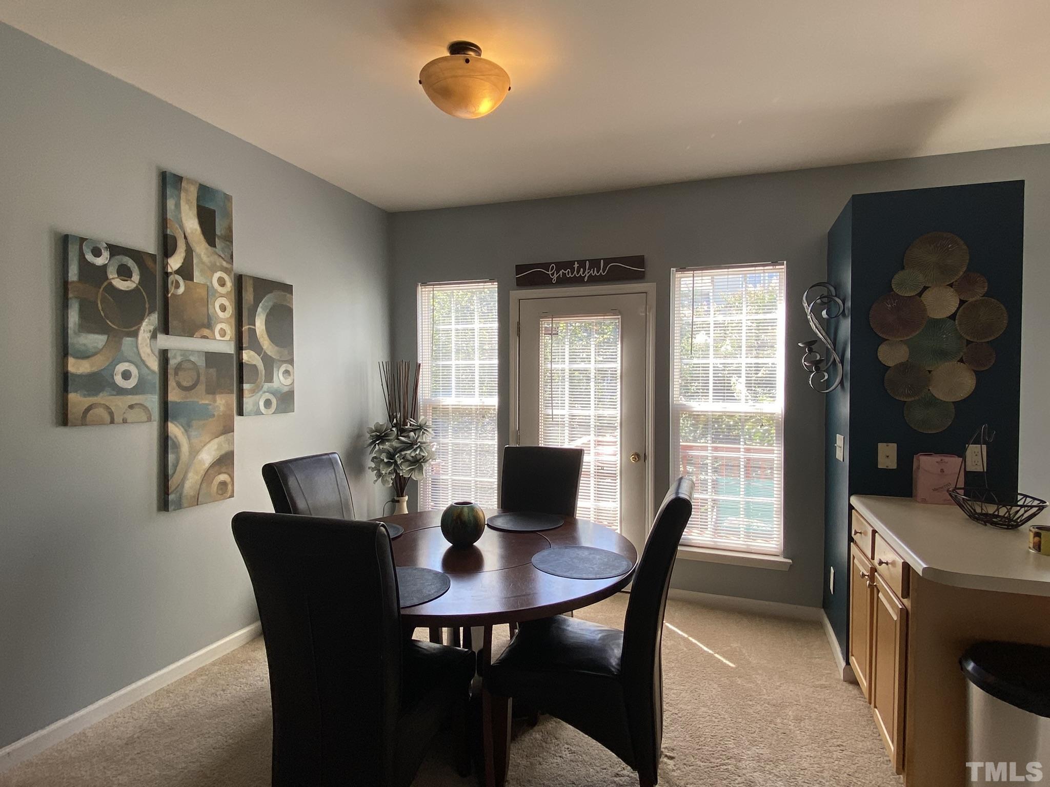 7251 Galon Glen Road Raleigh, NC 27613 - Photo 8 of 26 a view of a dining room with furniture and a window