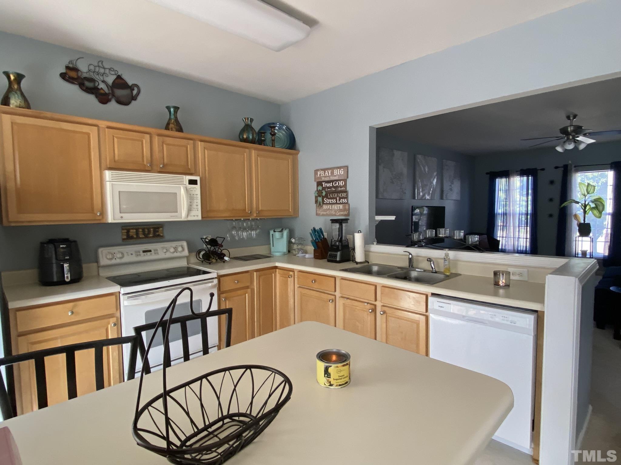 7251 Galon Glen Road Raleigh, NC 27613 - Photo 10 of 26 a kitchen with stainless steel appliances a sink a stove a table and chairs