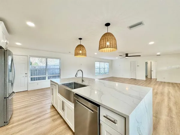 a kitchen with a sink a stove and cabinets