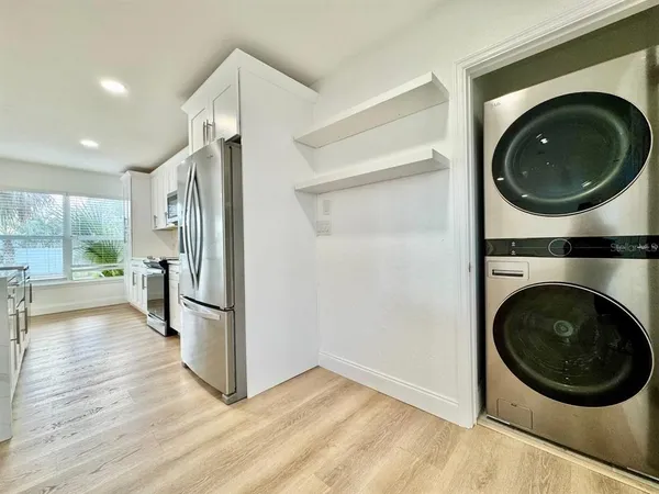 a view of a hallway with washer and dryer