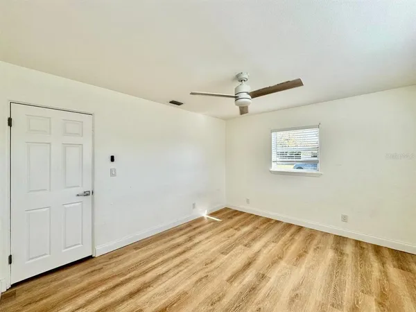 a view of a room with wooden floor