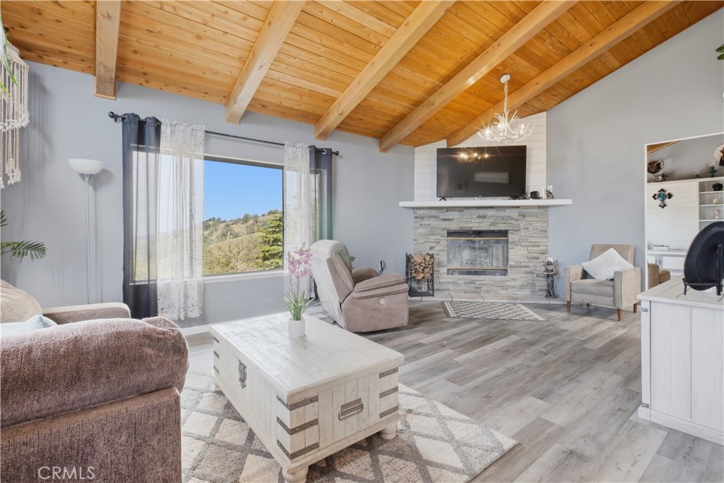 26201 Cumberland Road Tehachapi, CA 93561 - Photo 4 of 36 a living room with furniture a flat screen tv and a fireplace
