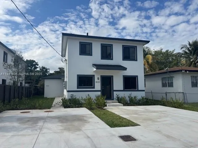 a front view of a house with a yard and a garage