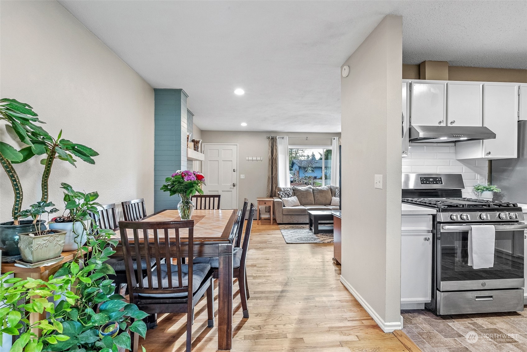 2313 Maple Lane Steilacoom, WA 98388 - Photo 12 of 40 a dining room with furniture potted plants and wooden floor