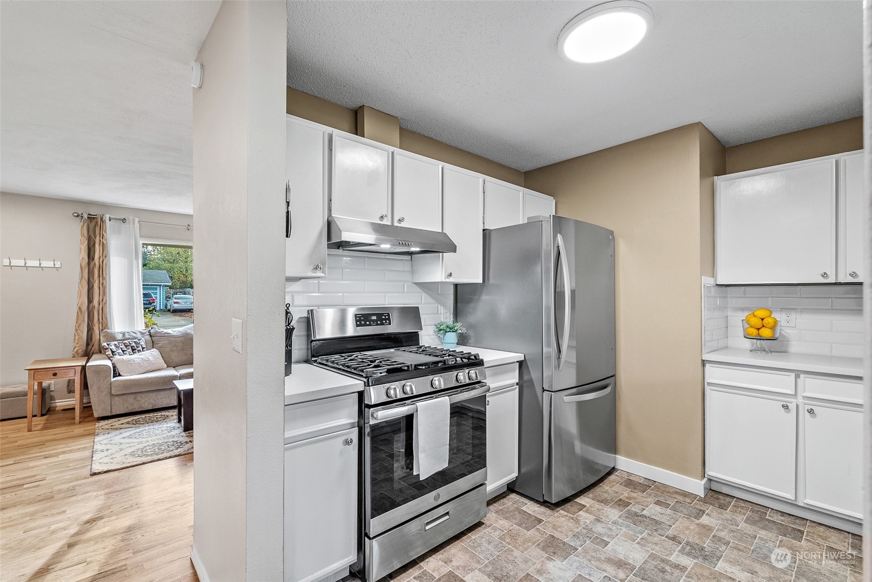 2313 Maple Lane Steilacoom, WA 98388 - Photo 13 of 40 a kitchen with stainless steel appliances a stove a refrigerator and a sink