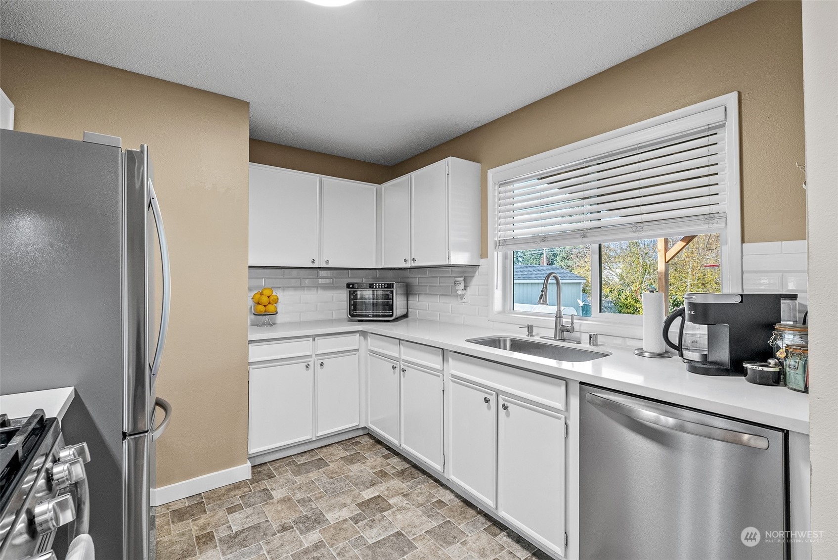 2313 Maple Lane Steilacoom, WA 98388 - Photo 14 of 40 a kitchen with a sink stove and refrigerator