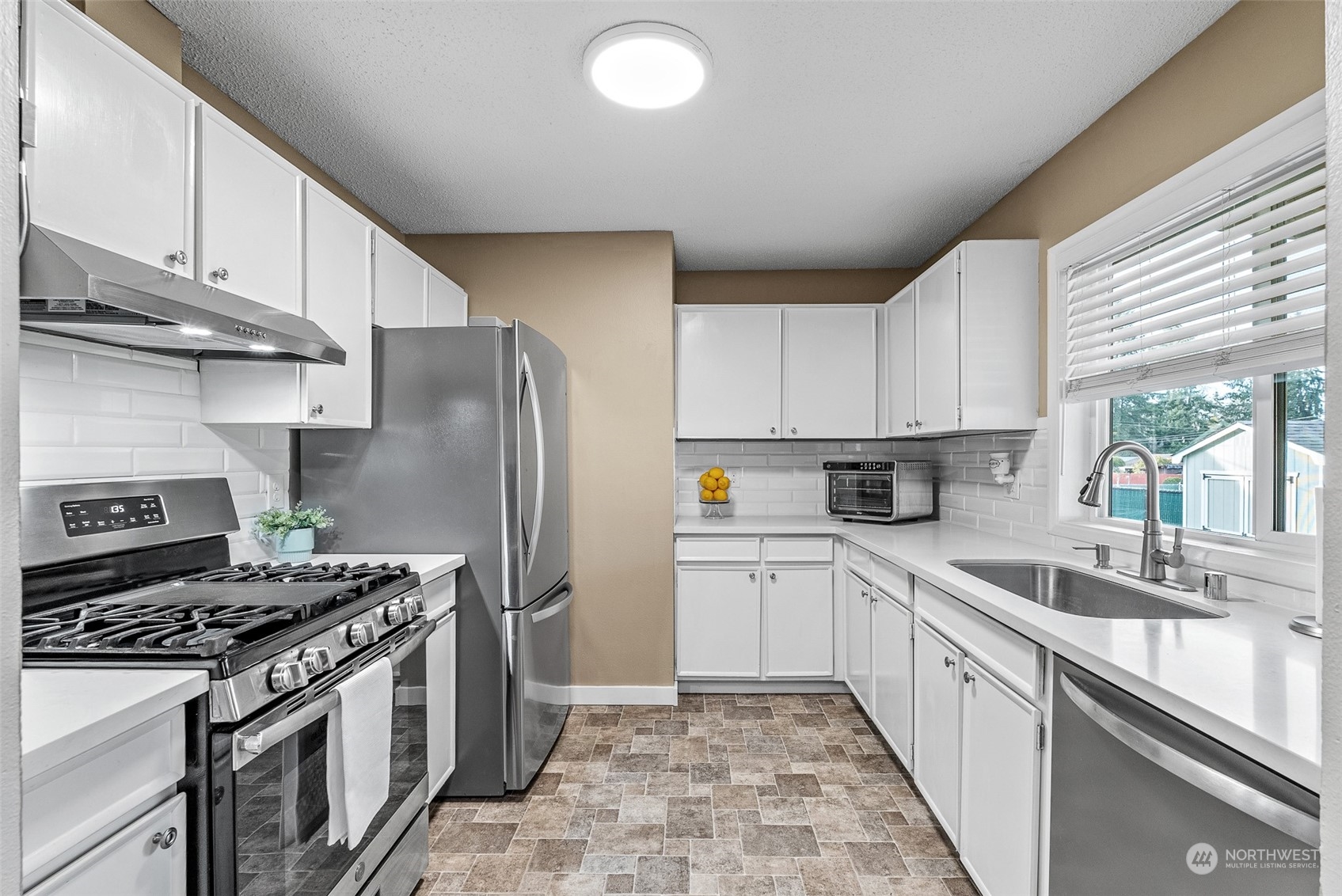 2313 Maple Lane Steilacoom, WA 98388 - Photo 15 of 40 a kitchen with a stove a sink and a refrigerator