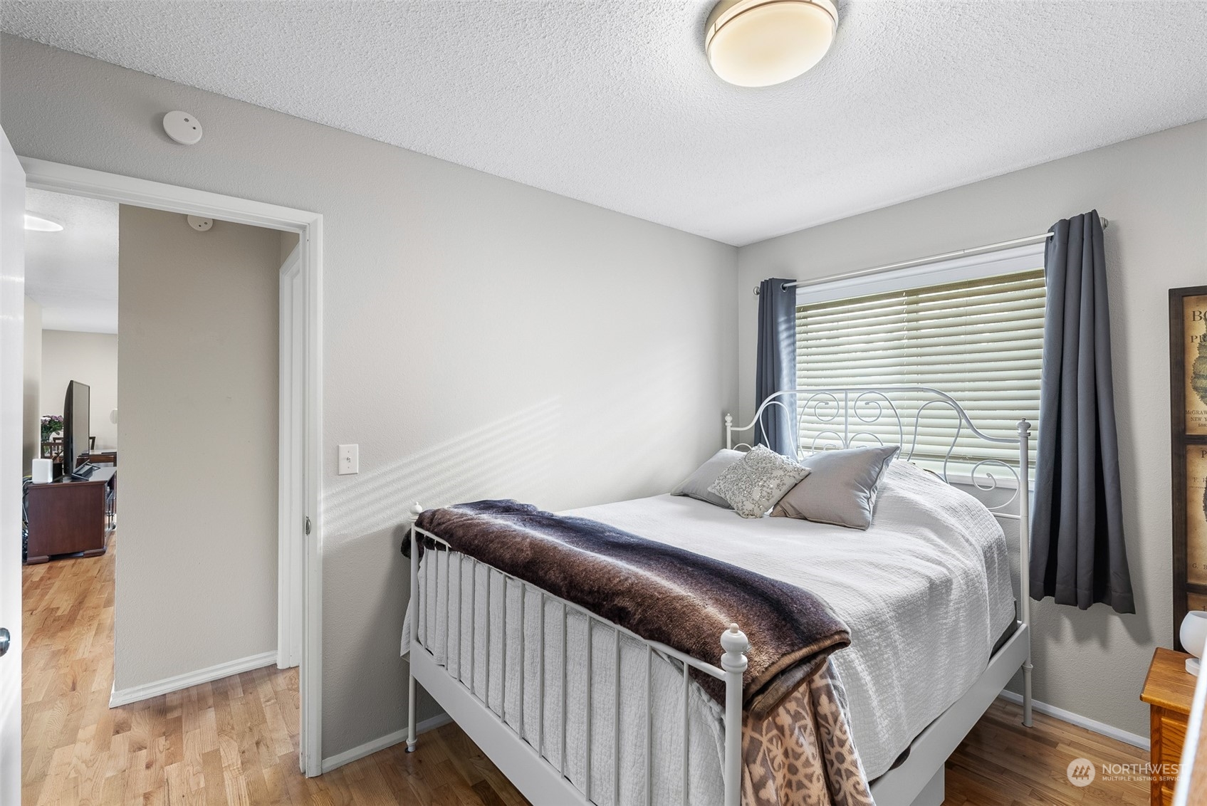2313 Maple Lane Steilacoom, WA 98388 - Photo 25 of 40 a bedroom with a bed and wooden floor