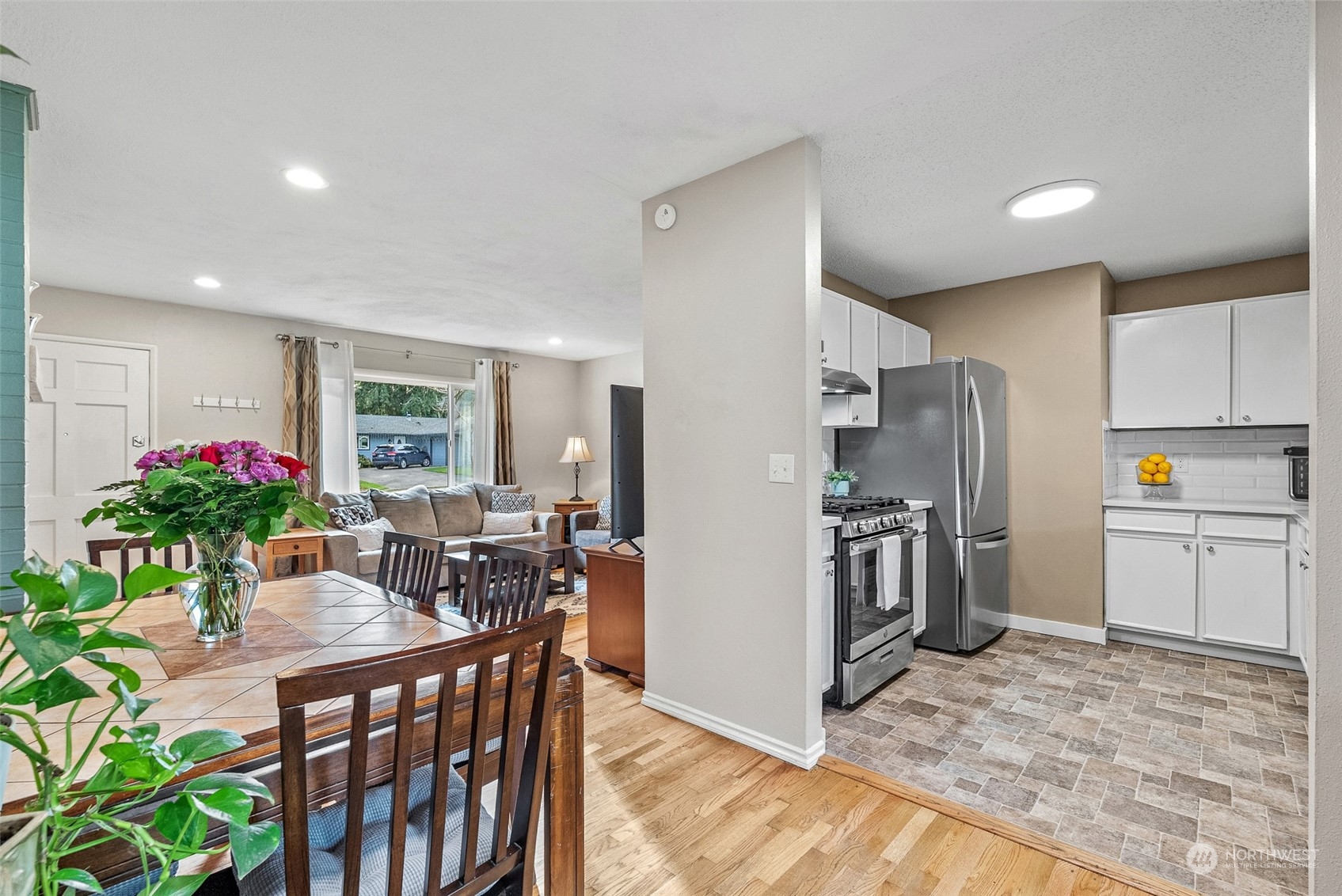 2313 Maple Lane Steilacoom, WA 98388 - Photo 10 of 40 a kitchen with stainless steel appliances kitchen island granite countertop a refrigerator and a sink