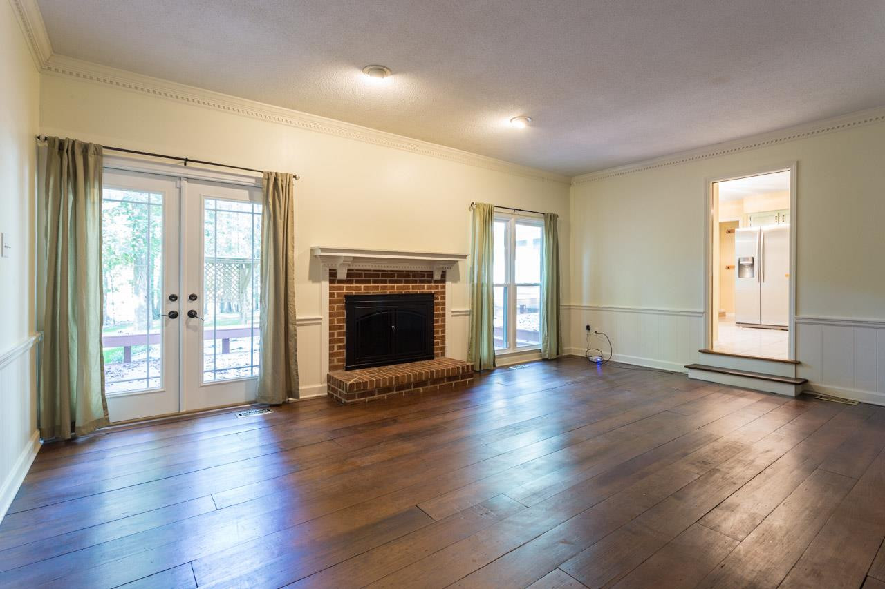 10205 Bushveld Lane Raleigh, NC 27613 - Photo 8 of 22 Wood burning fireplace and access to expansive deck Family Room