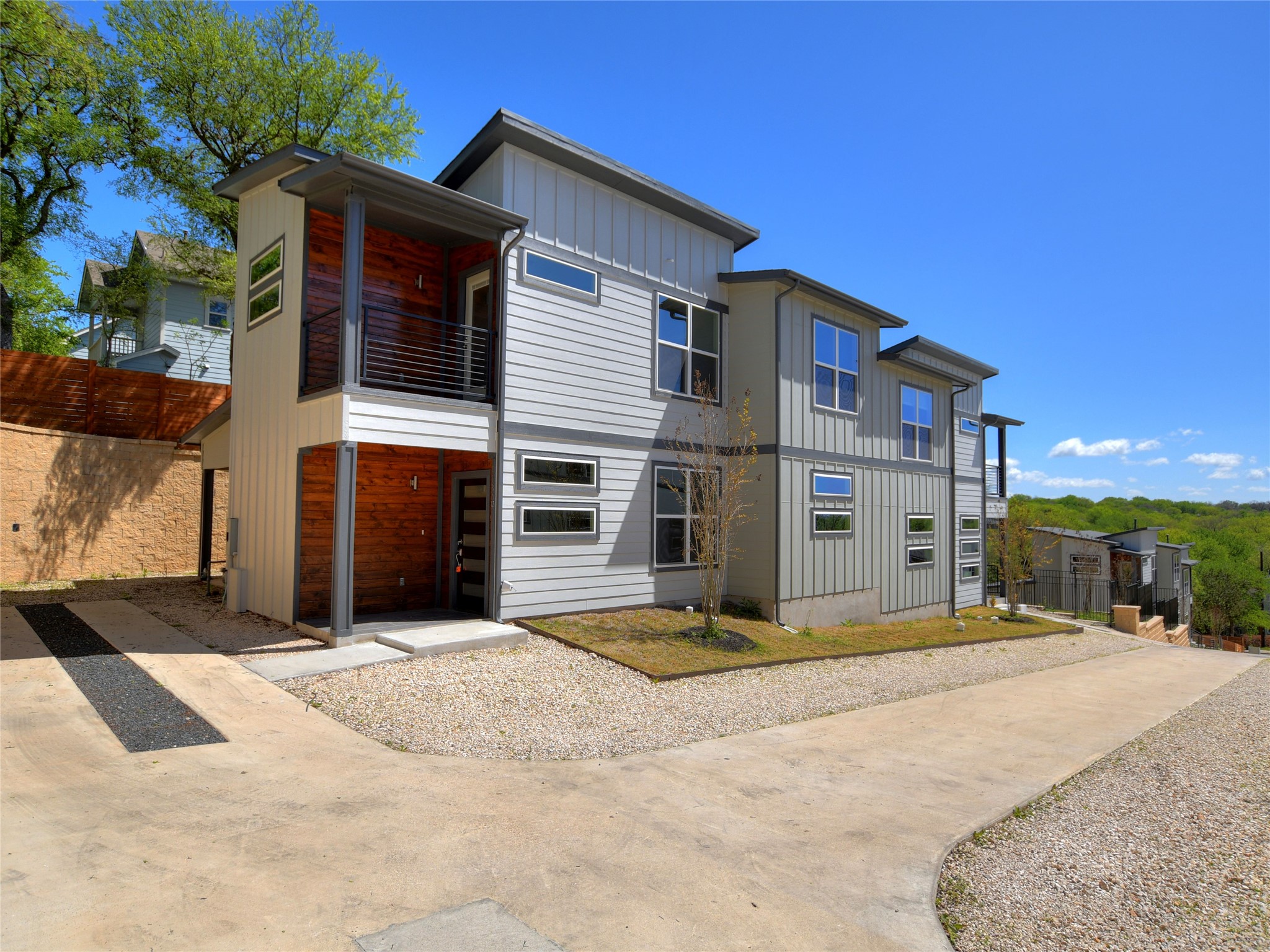 View of front of house with a balcony and board and batten siding
