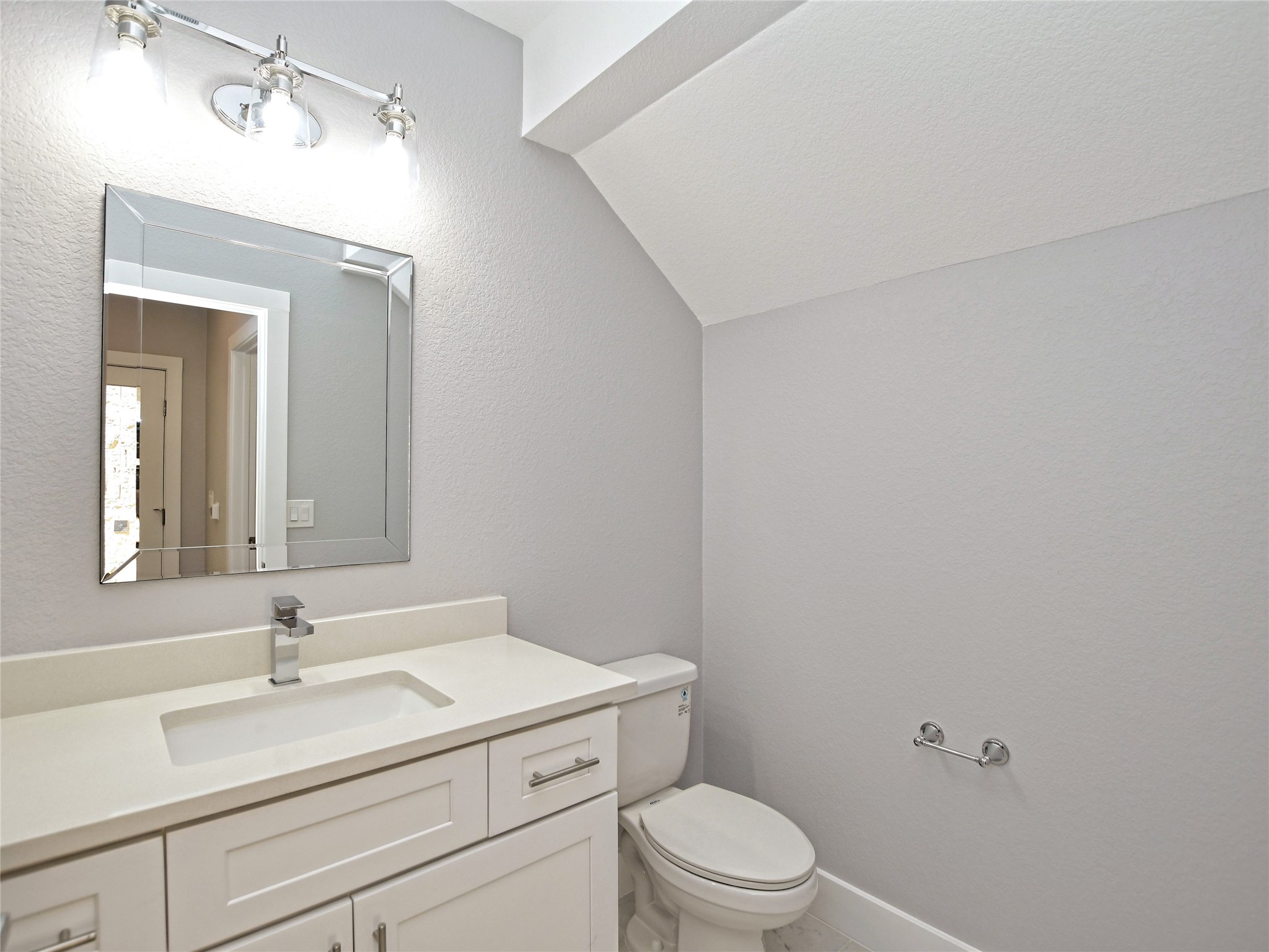 1130 Lott Avenue, Unit B Austin, TX 78721 - Photo 12 of 29 Bathroom with lofted ceiling, vanity, and a textured wall
