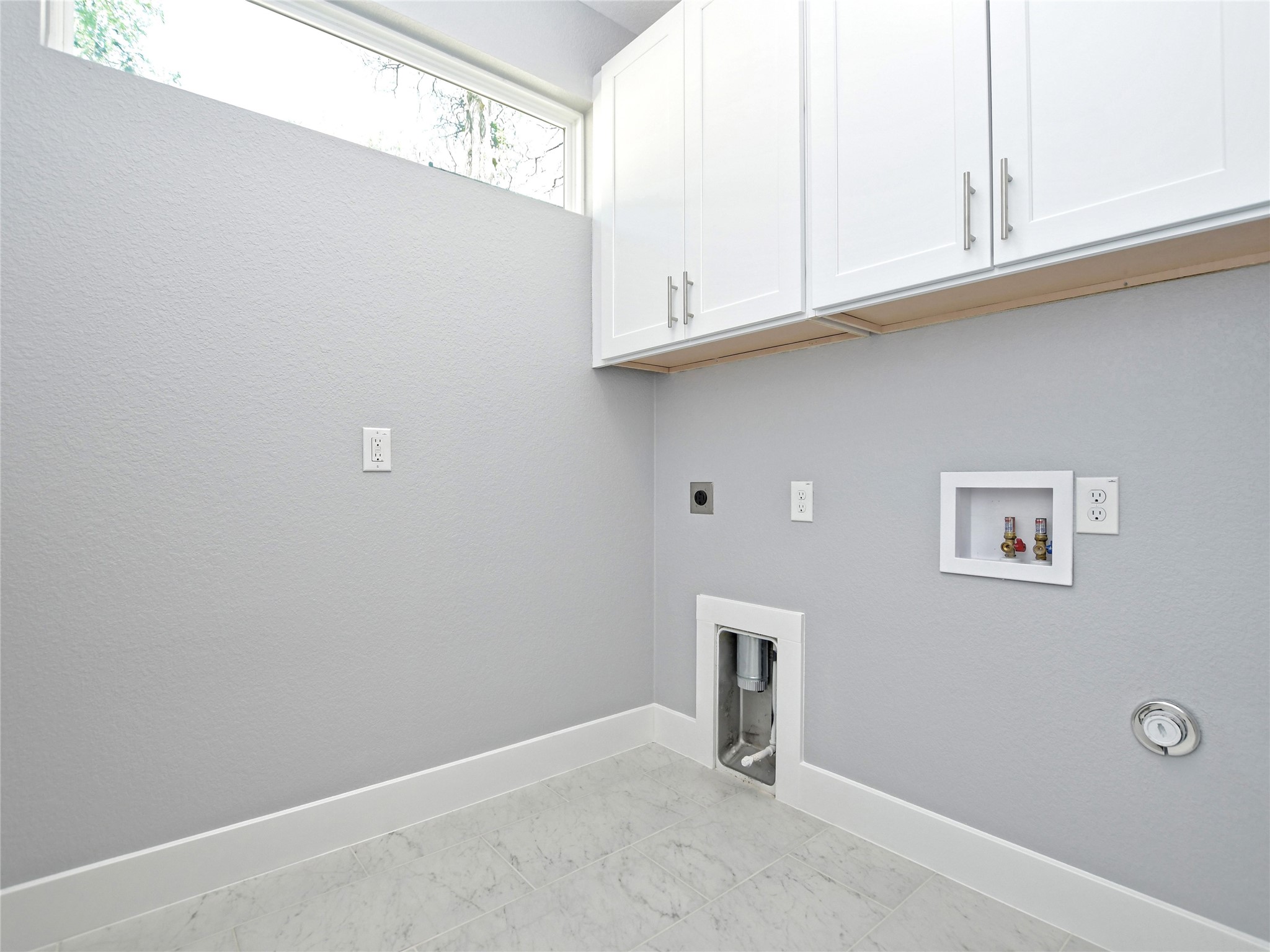 1130 Lott Avenue, Unit B Austin, TX 78721 - Photo 13 of 29 Laundry area with hookup for an electric dryer, washer hookup, cabinet space, and gas dryer hookup