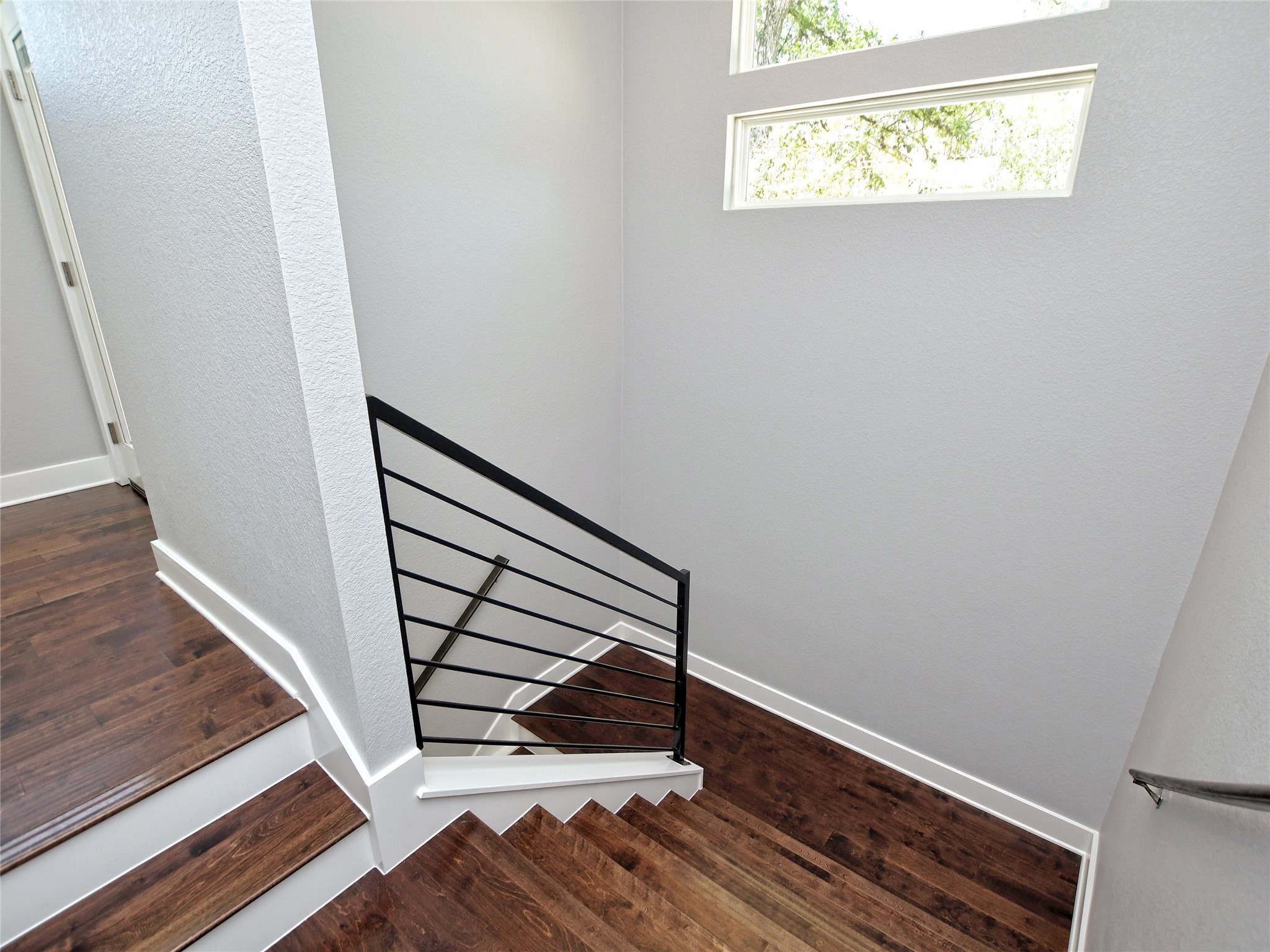 1130 Lott Avenue, Unit B Austin, TX 78721 - Photo 15 of 29 Stairs with a textured wall and wood finished floors