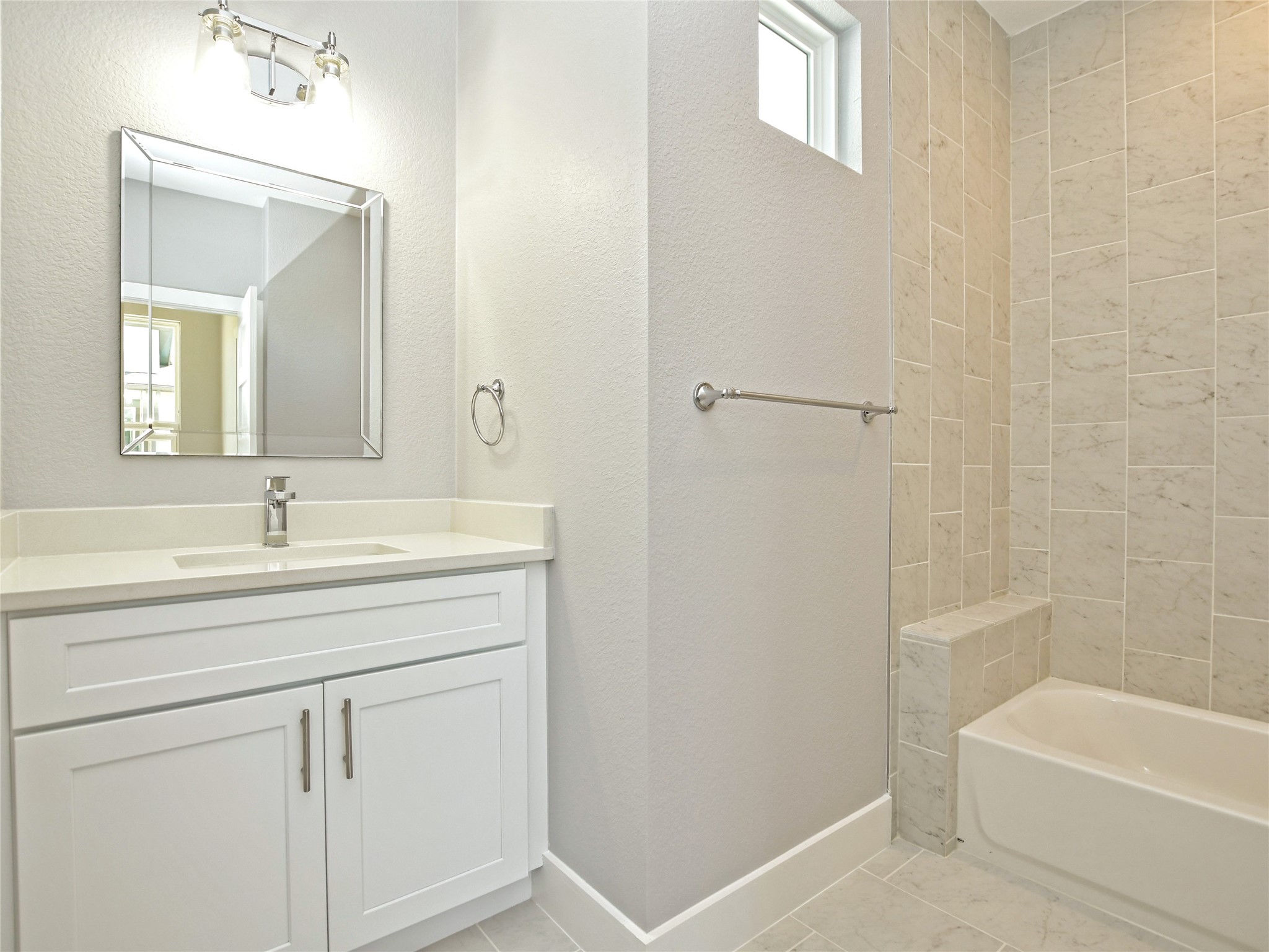 1130 Lott Avenue, Unit B Austin, TX 78721 - Photo 23 of 29 Bathroom with vanity, shower / washtub combination, a textured wall, and light tile patterned floors