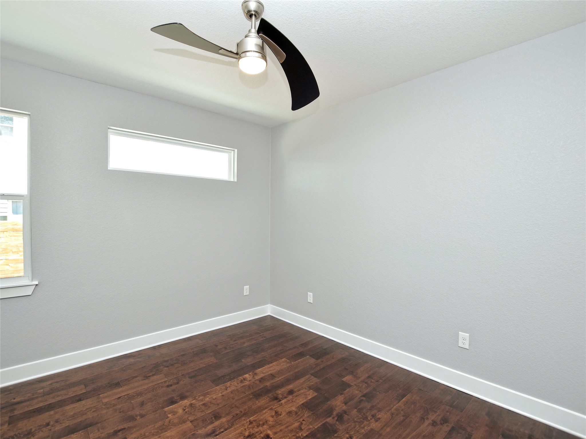 1130 Lott Avenue, Unit B Austin, TX 78721 - Photo 25 of 29 Unfurnished room featuring dark wood finished floors and ceiling fan