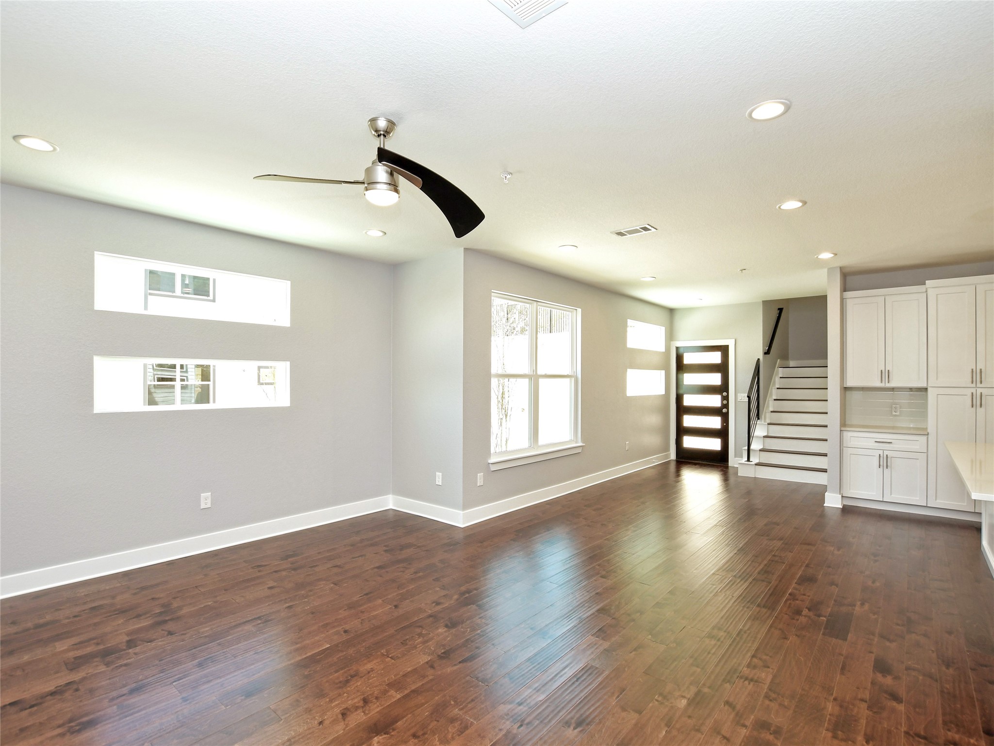 1130 Lott Avenue, Unit B Austin, TX 78721 - Photo 6 of 29 Unfurnished living room with dark wood-style floors, a ceiling fan, and recessed lighting