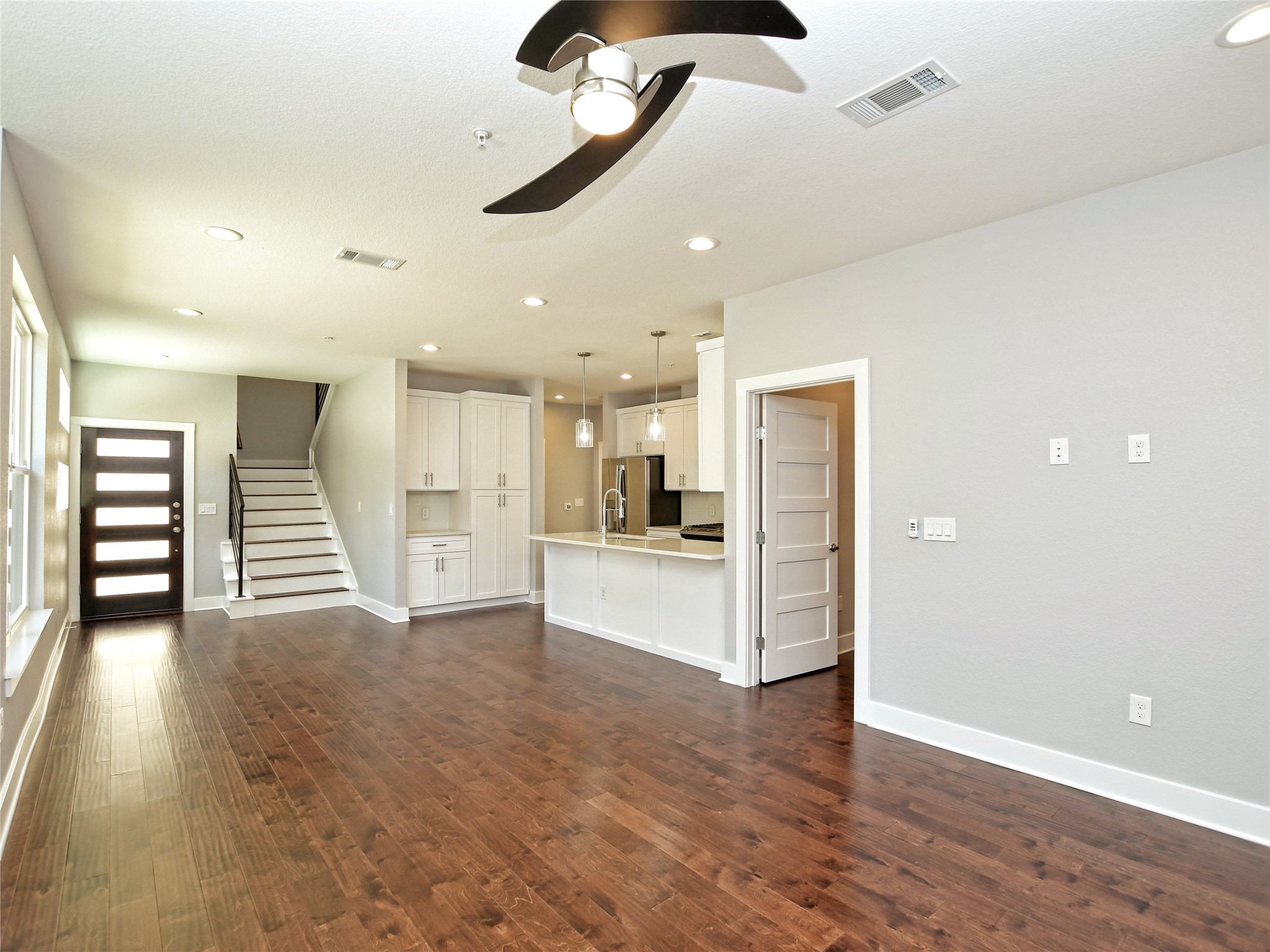 1130 Lott Avenue, Unit B Austin, TX 78721 - Photo 7 of 29 Unfurnished living room featuring ceiling fan, recessed lighting, and dark wood-style floors