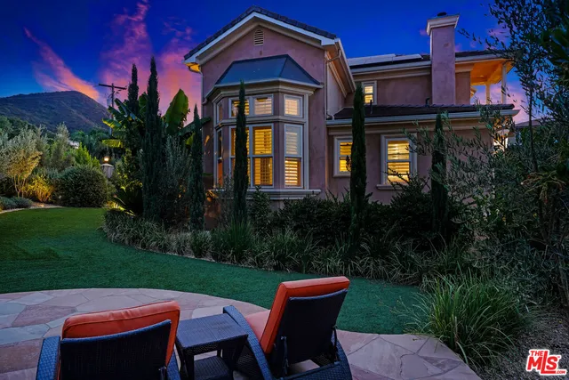 a view of an chairs and potted plant in the patio