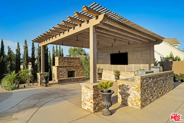 a view of backyard with outdoor seating and trees
