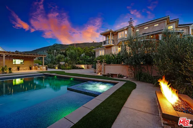 a view of a swimming pool with a patio and a yard