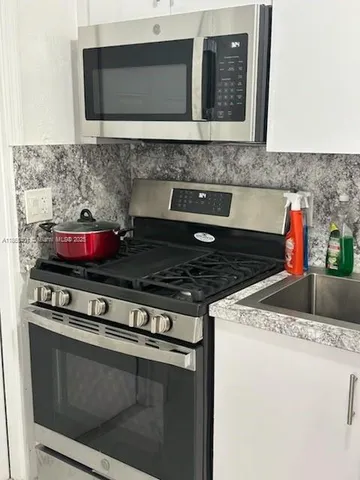 a kitchen with a stove and a microwave