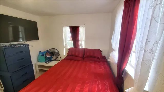 a bed room with a bed and a television