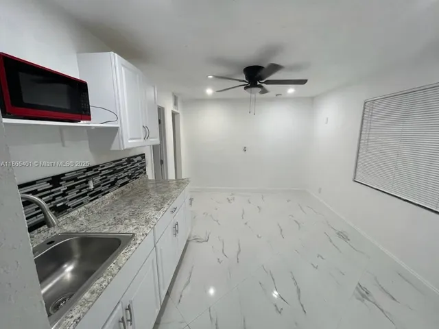 a kitchen with a stove and a microwave