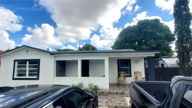 a view of house with a chairs in patio