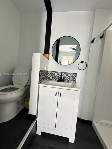 a bathroom with a toilet a sink and a mirror