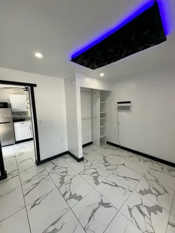 a view of a livingroom with wooden floor and more cabinets