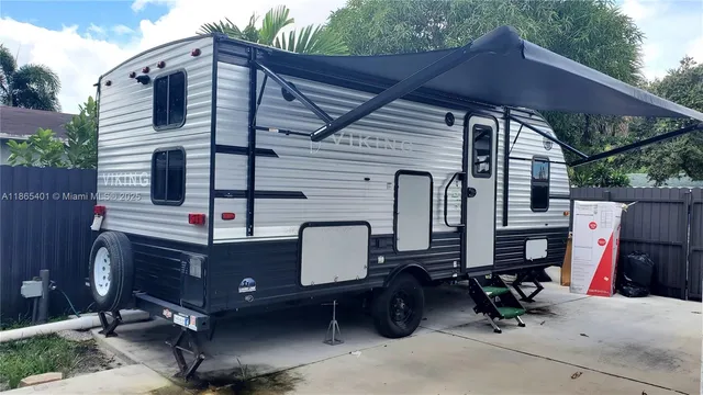 a view of backyard with wheel chair and potted plants