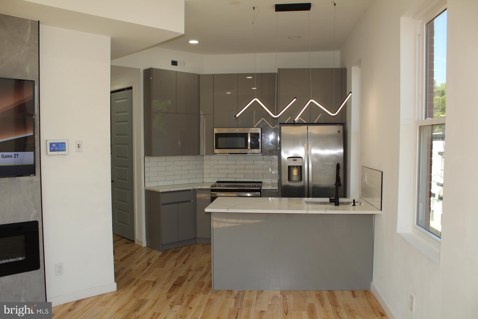 3017 Ridge Avenue, Unit C Philadelphia, PA 19121 - Photo 9 of 27 Sleek modern kitchen with stylish accents.
