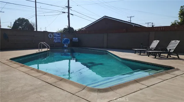 a roof deck with table and chairs