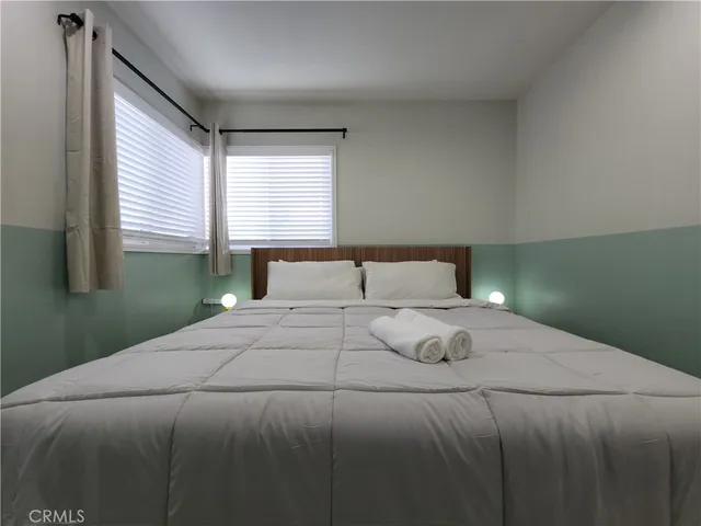 a bedroom with a bed and window