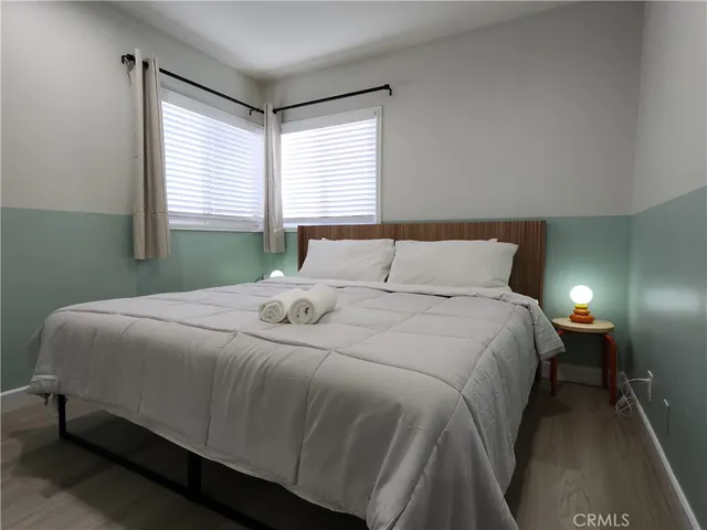 a bedroom with a bed and window