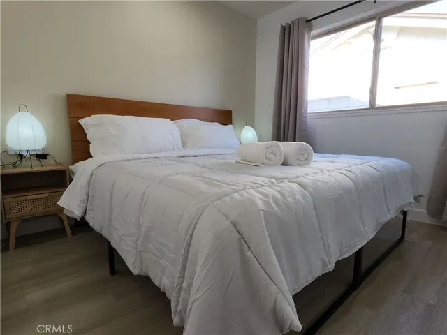 a bedroom with bed and a large window