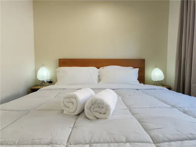 a bedroom with a bed and window