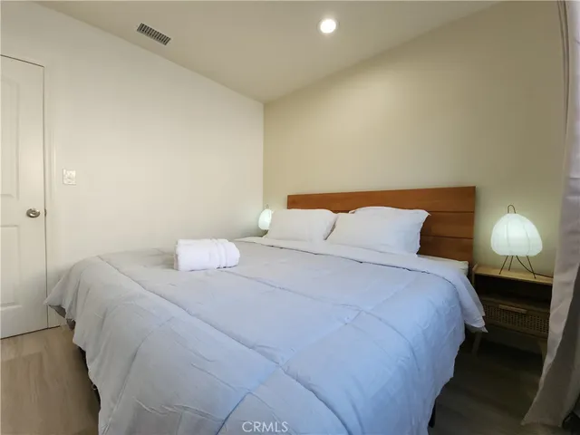 a bedroom with a bed and a lamp