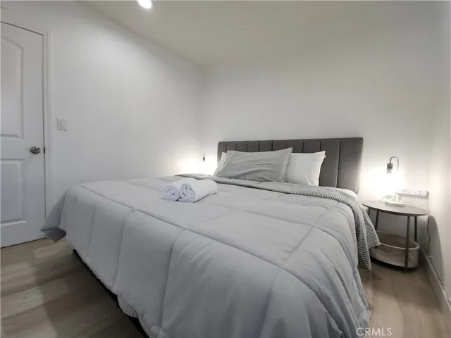 a bedroom with a bed and a night stand