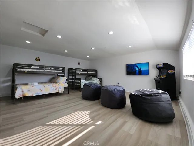 a bedroom with furniture and a wooden floor